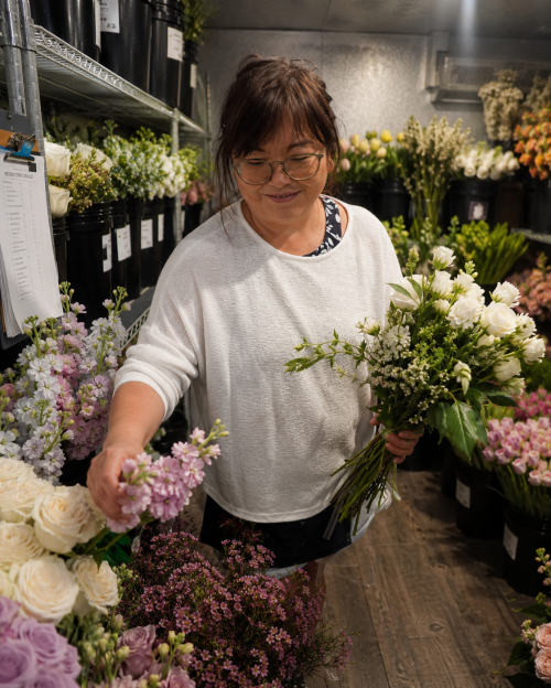 Sandi in cooler picking out flowers.png